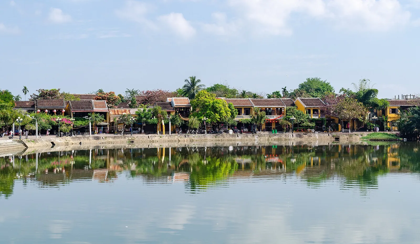 Riverside houses mirrored in the Thu Bon River