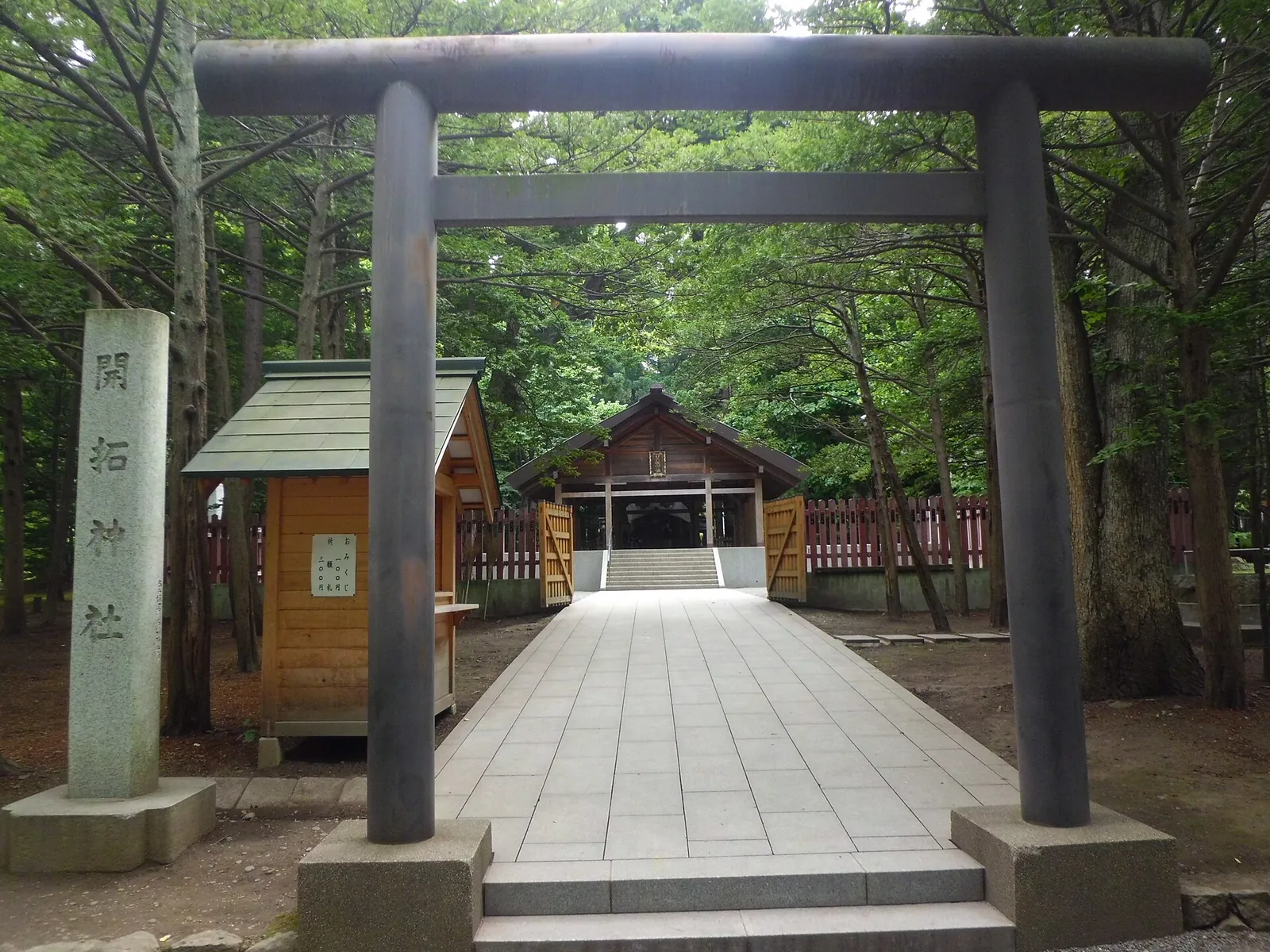 Wooden torii gate among trees at Hokkaido Shrine
