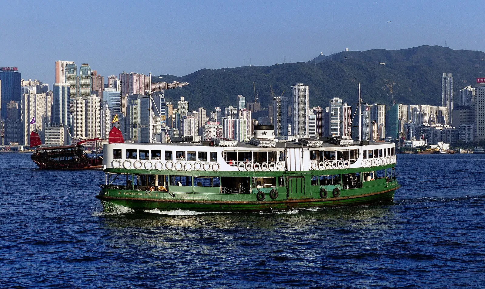 A Star Ferry crossing Victoria Harbour under blue skies