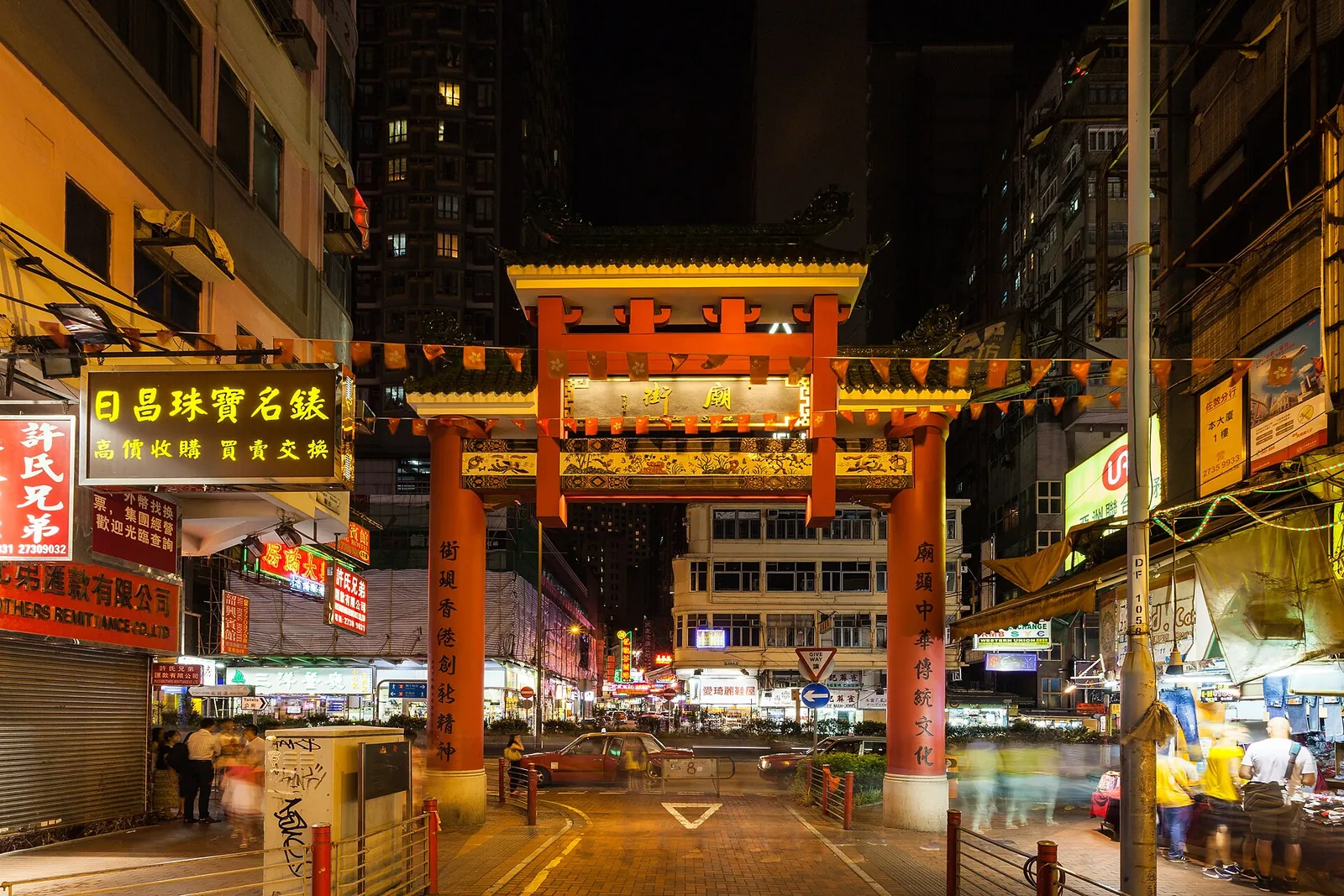 Temple Street's red gateway glowing at night