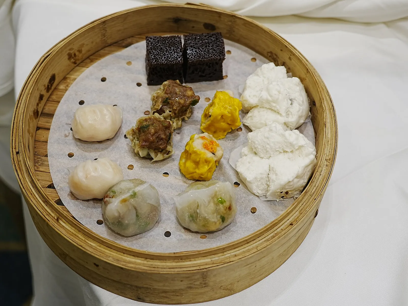 A bamboo basket of colourful Hong Kong dim sum