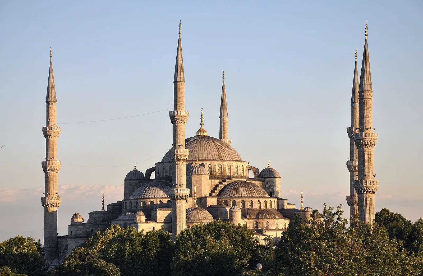 The Blue Mosque's domes and minarets in warm evening light