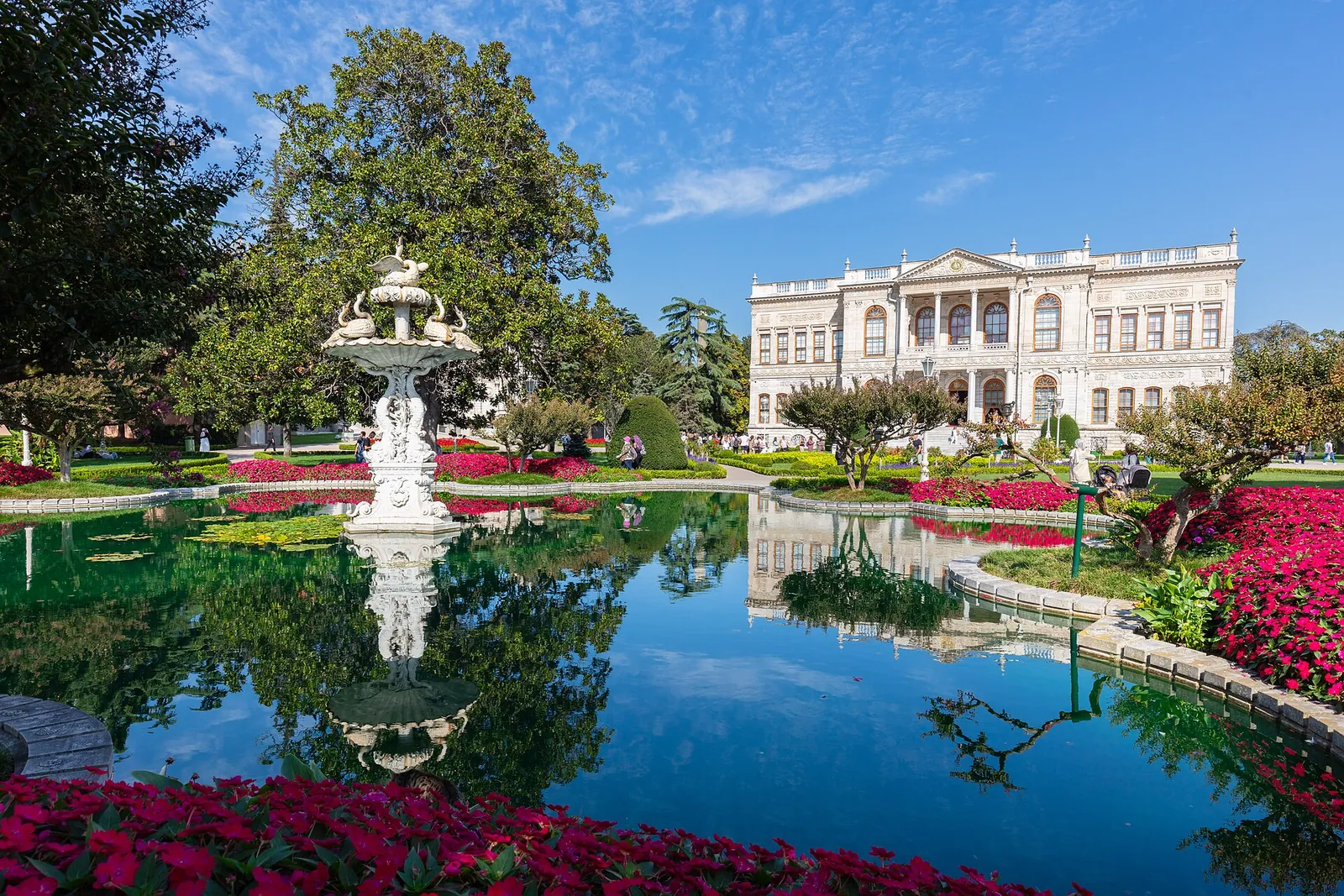 Dolmabahçe Palace gardens with a fountain and flowerbeds