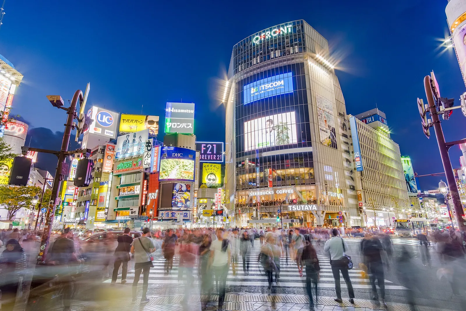 Shibuya scramble crossing glowing at dusk