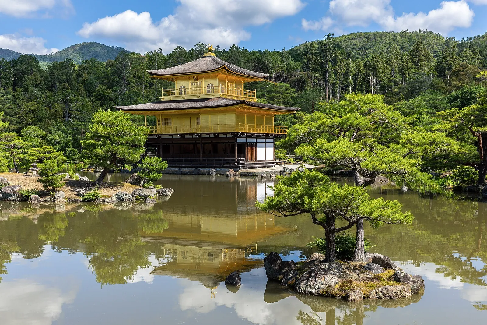 Golden Pavilion reflected in its pond on a sunny day