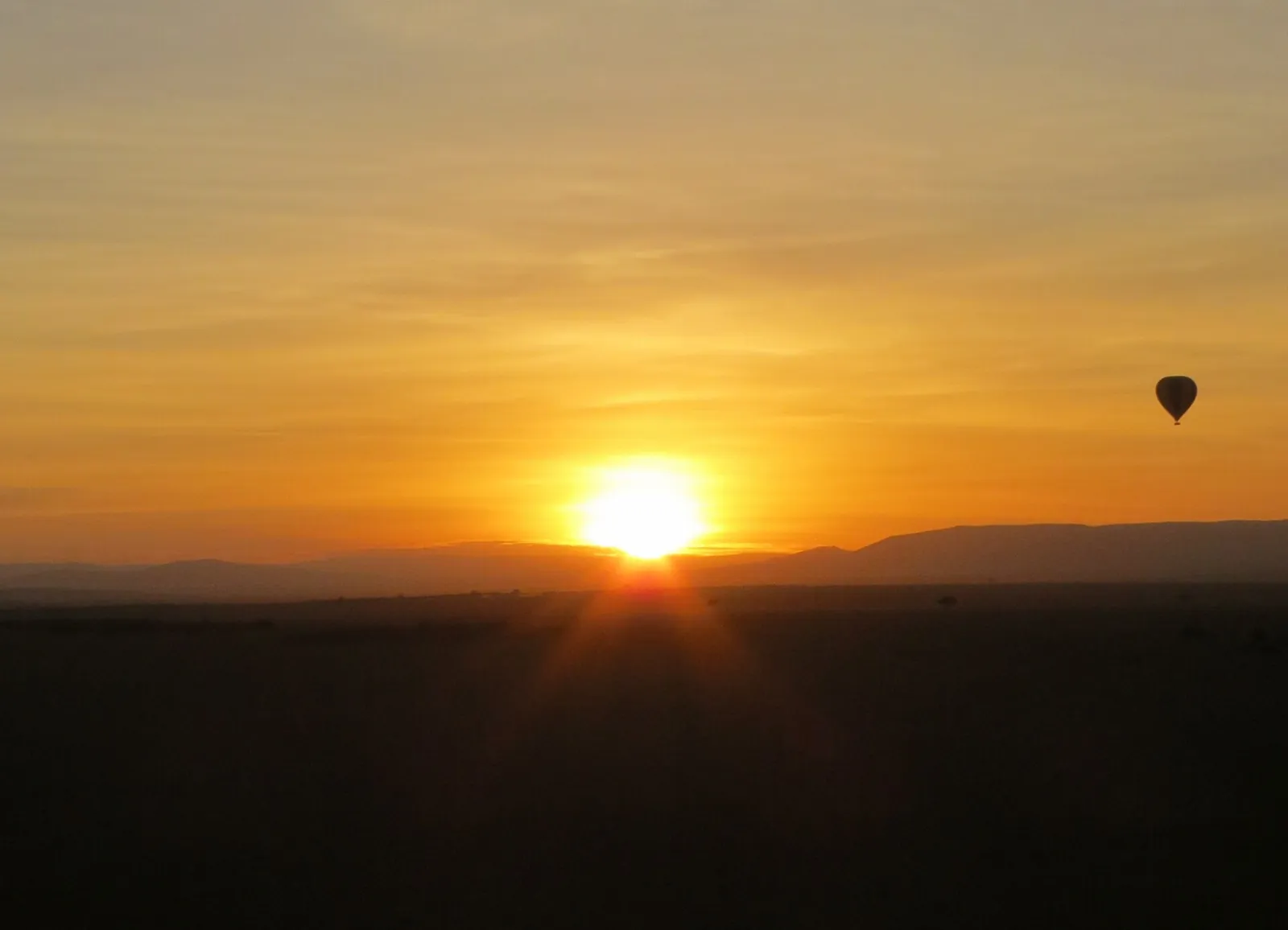 Sunrise and a balloon over the Masai Mara