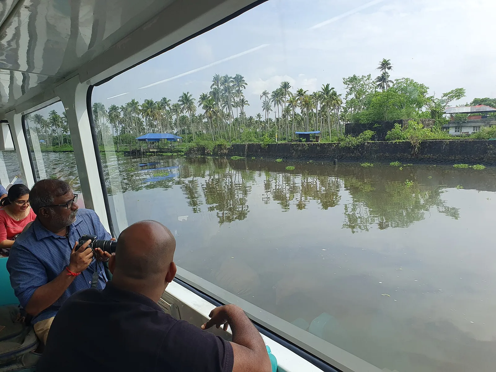 Palm-lined shore seen from a Kochi Water Metro boat