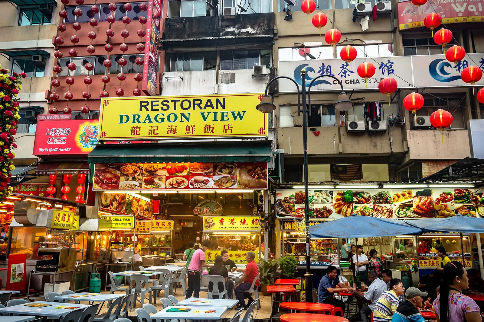 Busy open-air food stalls on Jalan Alor at night