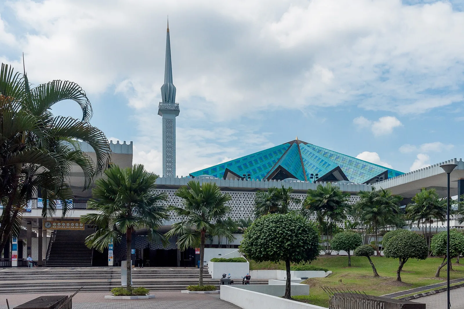 National Mosque minaret and blue roof framed by palms