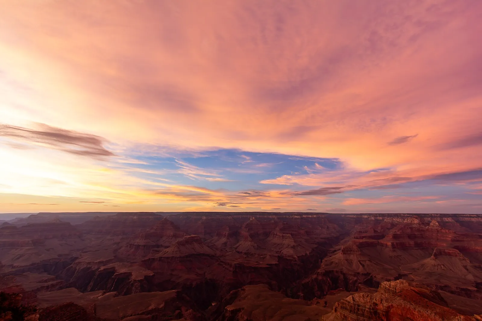 Pink sunset sky over the Grand Canyon from the South Rim