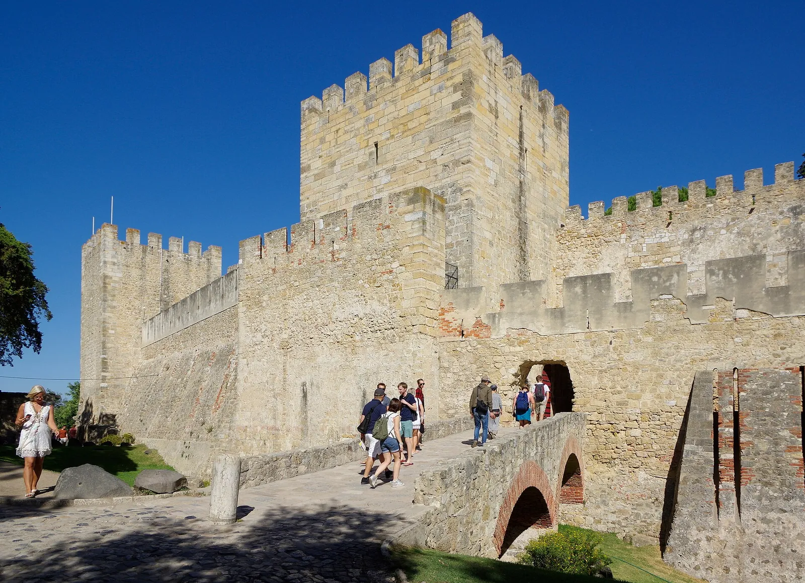 Stone walls of Castelo de São Jorge under a blue sky