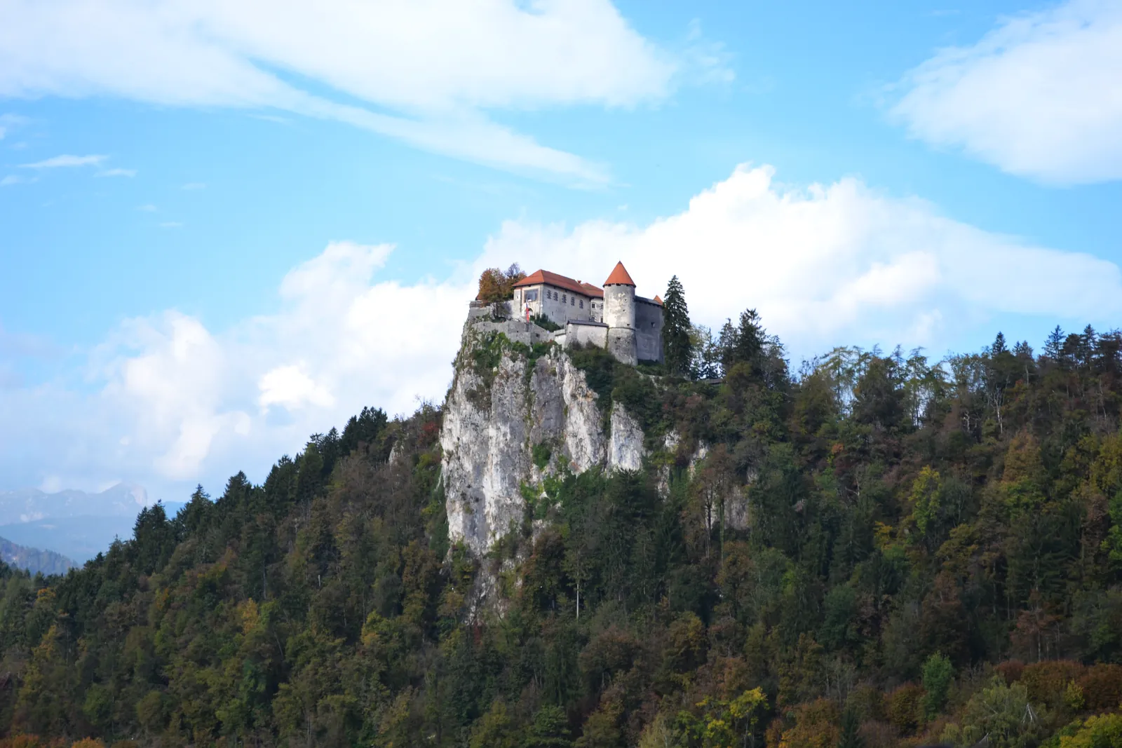 Bled Castle perched on its cliff under a blue sky