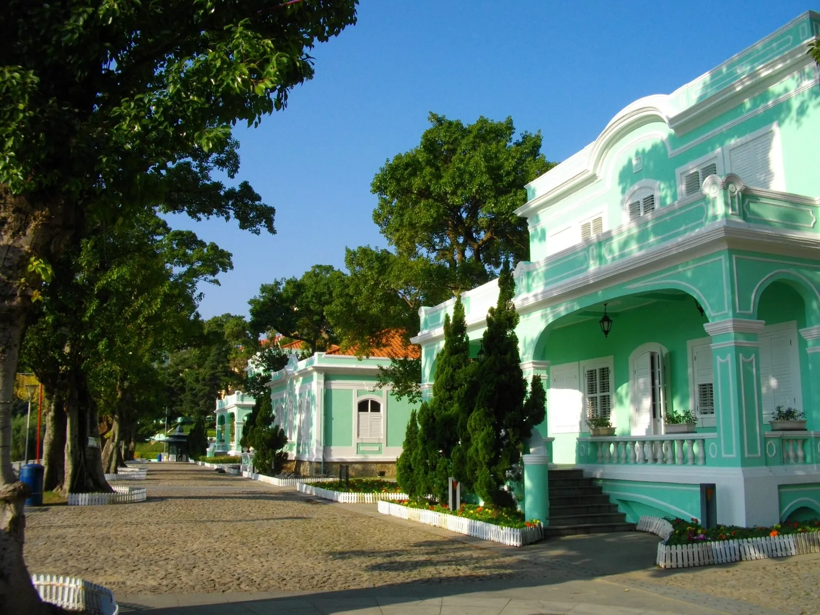 Mint-green Taipa Houses on a sunny day