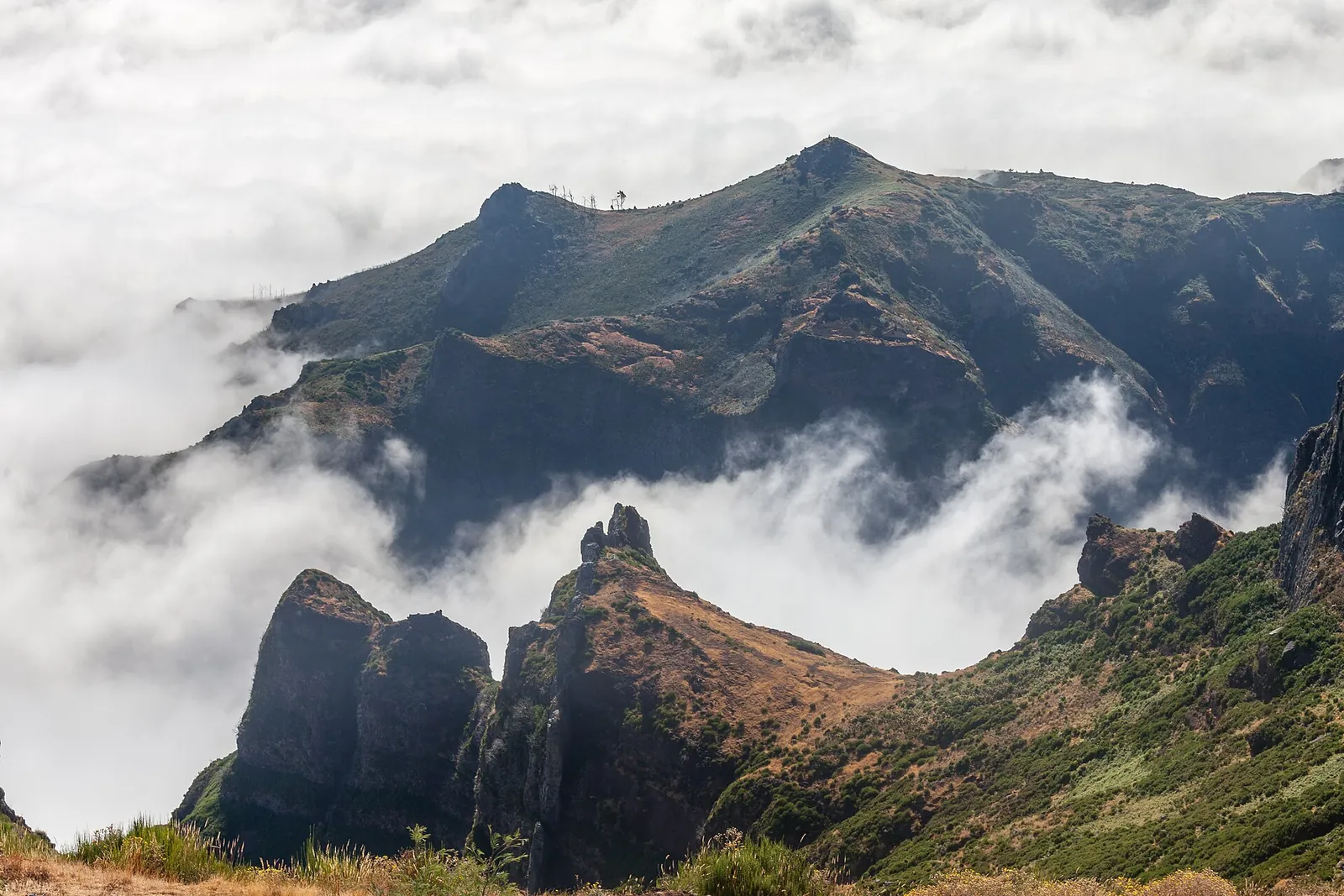 Jagged peaks rising above the clouds at Pico do Areeiro