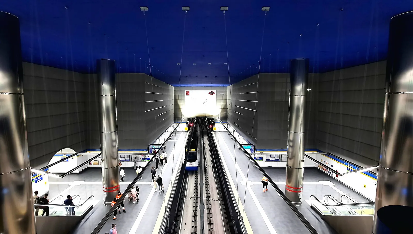 Bright Madrid Metro platform with a train arriving