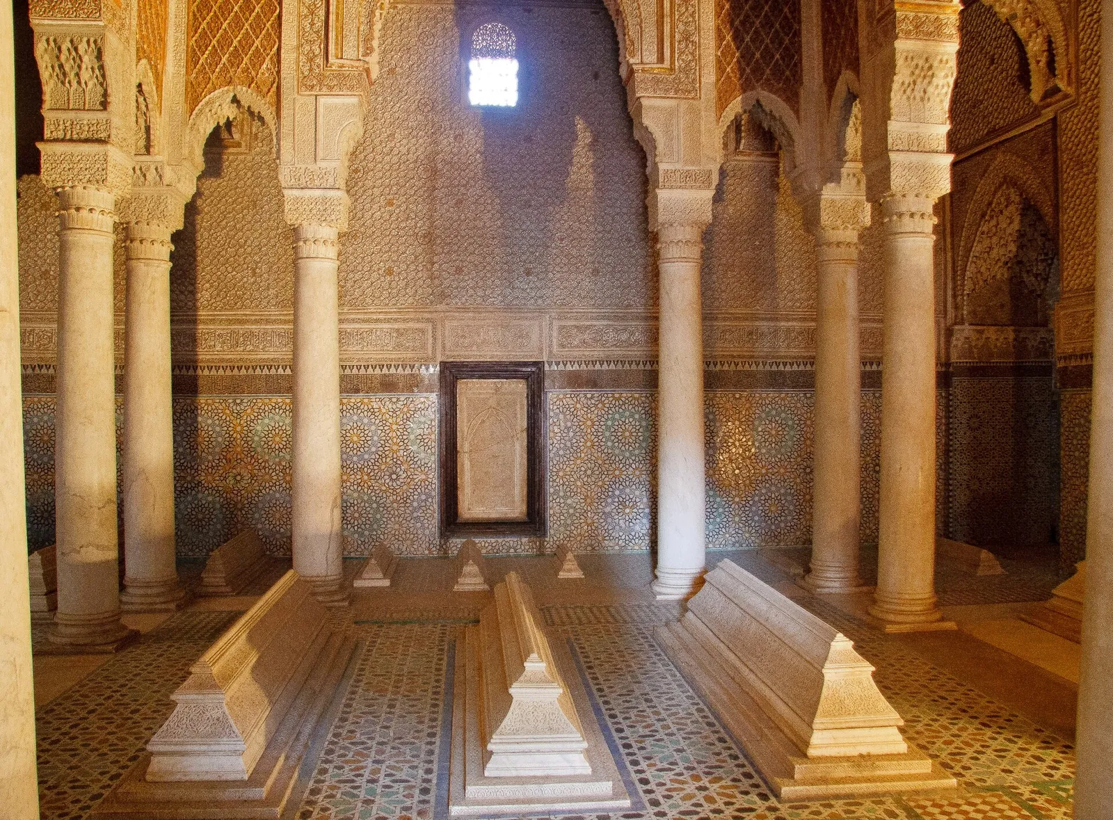 Marble tombs under carved arches at the Saadian Tombs