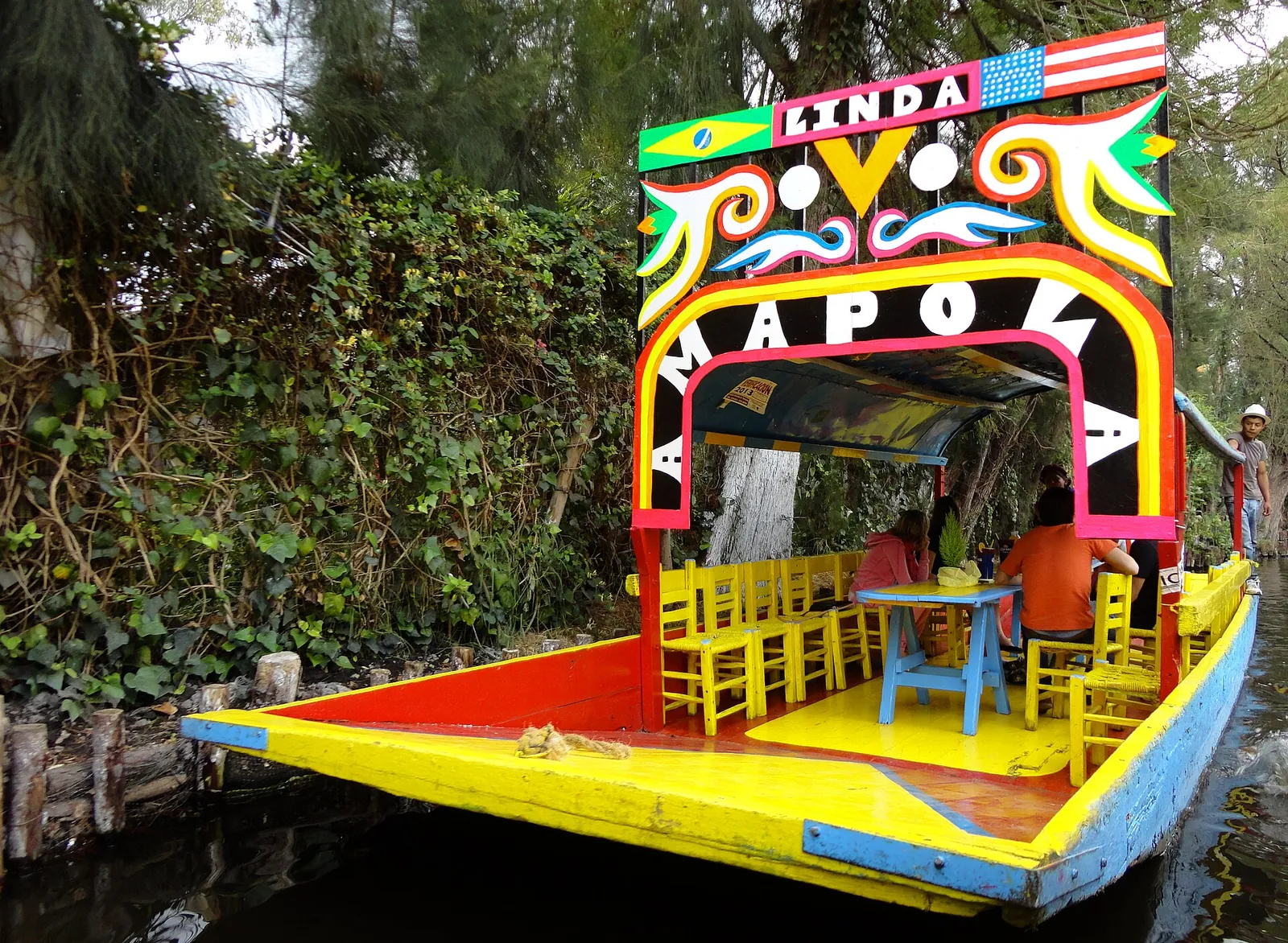A brightly painted trajinera boat on a Xochimilco canal
