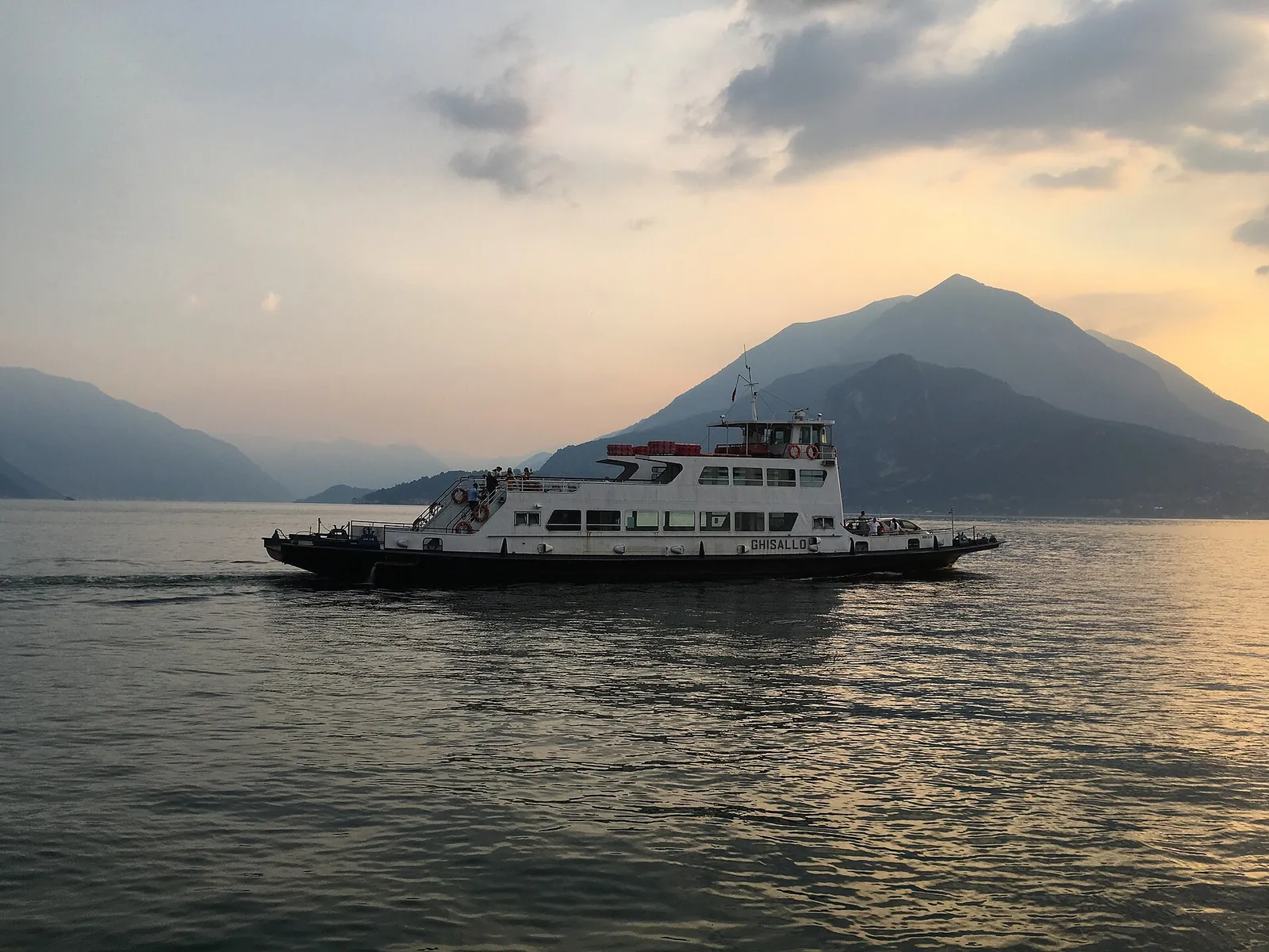 A Lake Como ferry gliding past the mountains