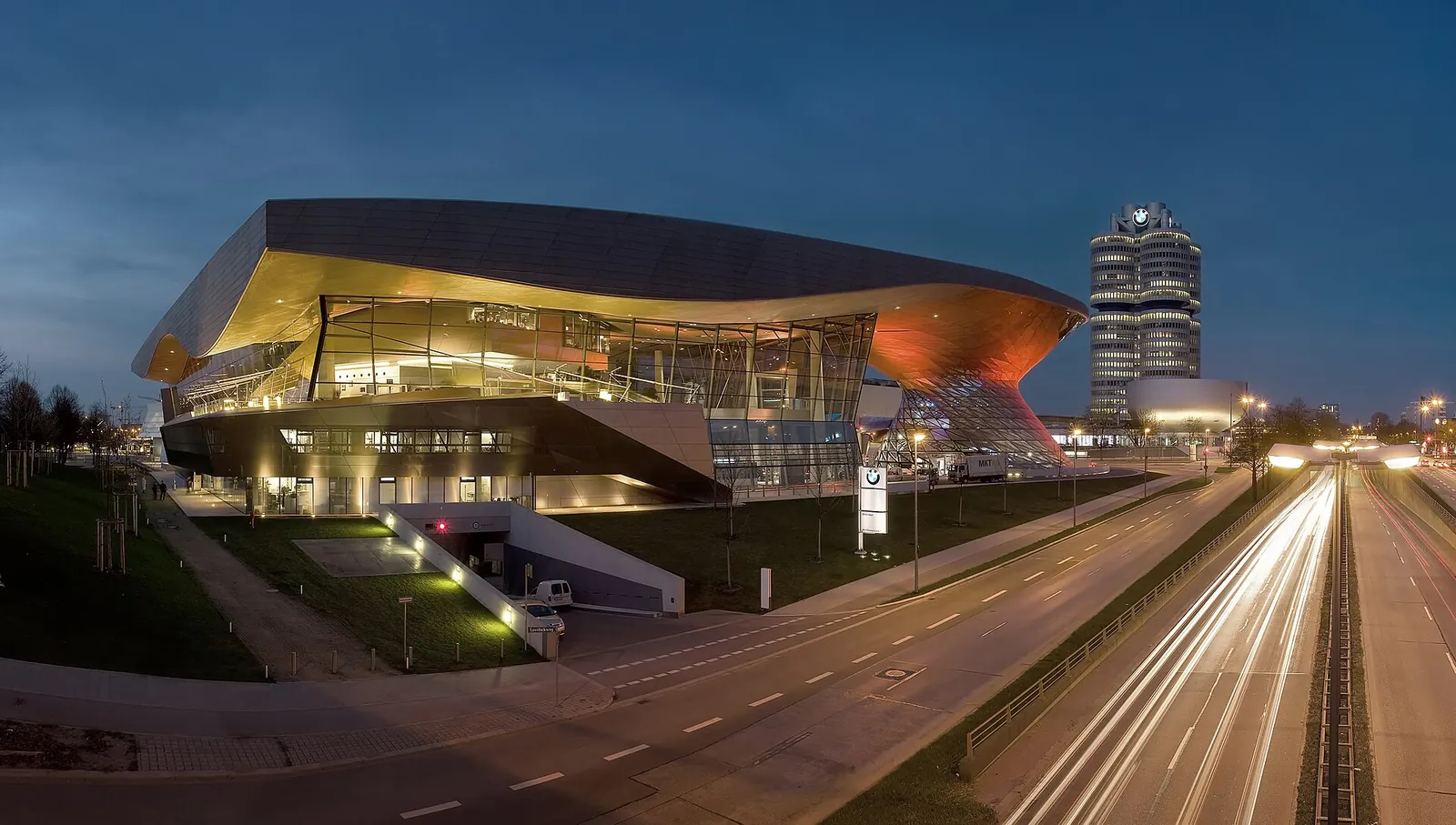 BMW Welt and the BMW tower glowing at dusk