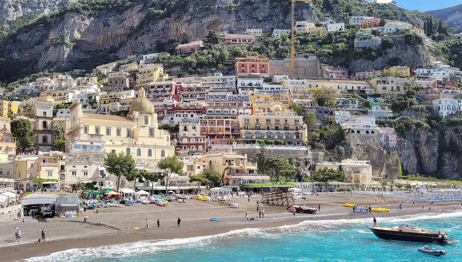 Positano's beach and hillside houses on a sunny day