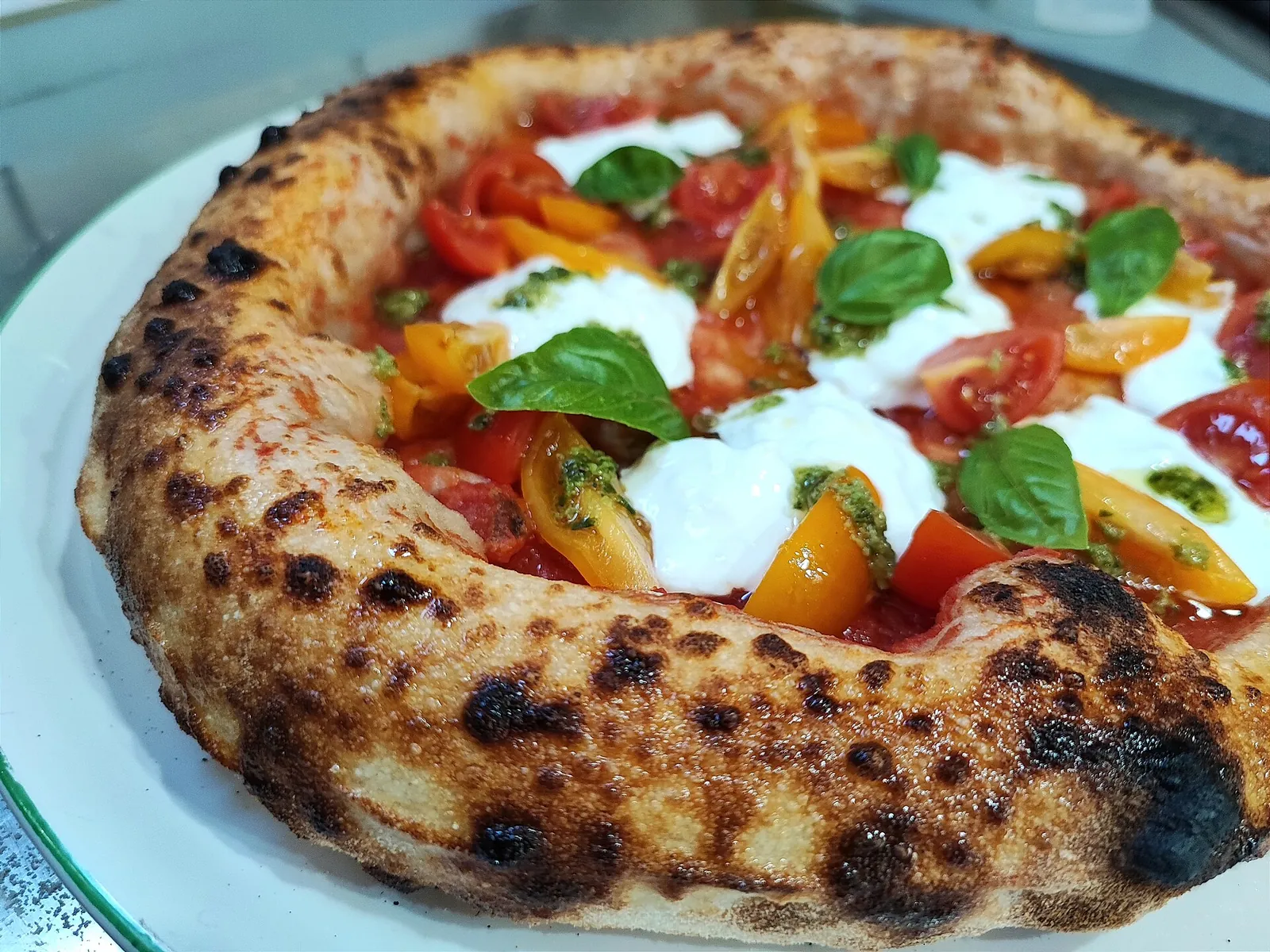 A puffy Neapolitan margherita with fresh basil