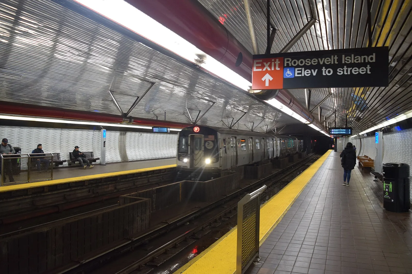 Subway train pulling into a bright New York station
