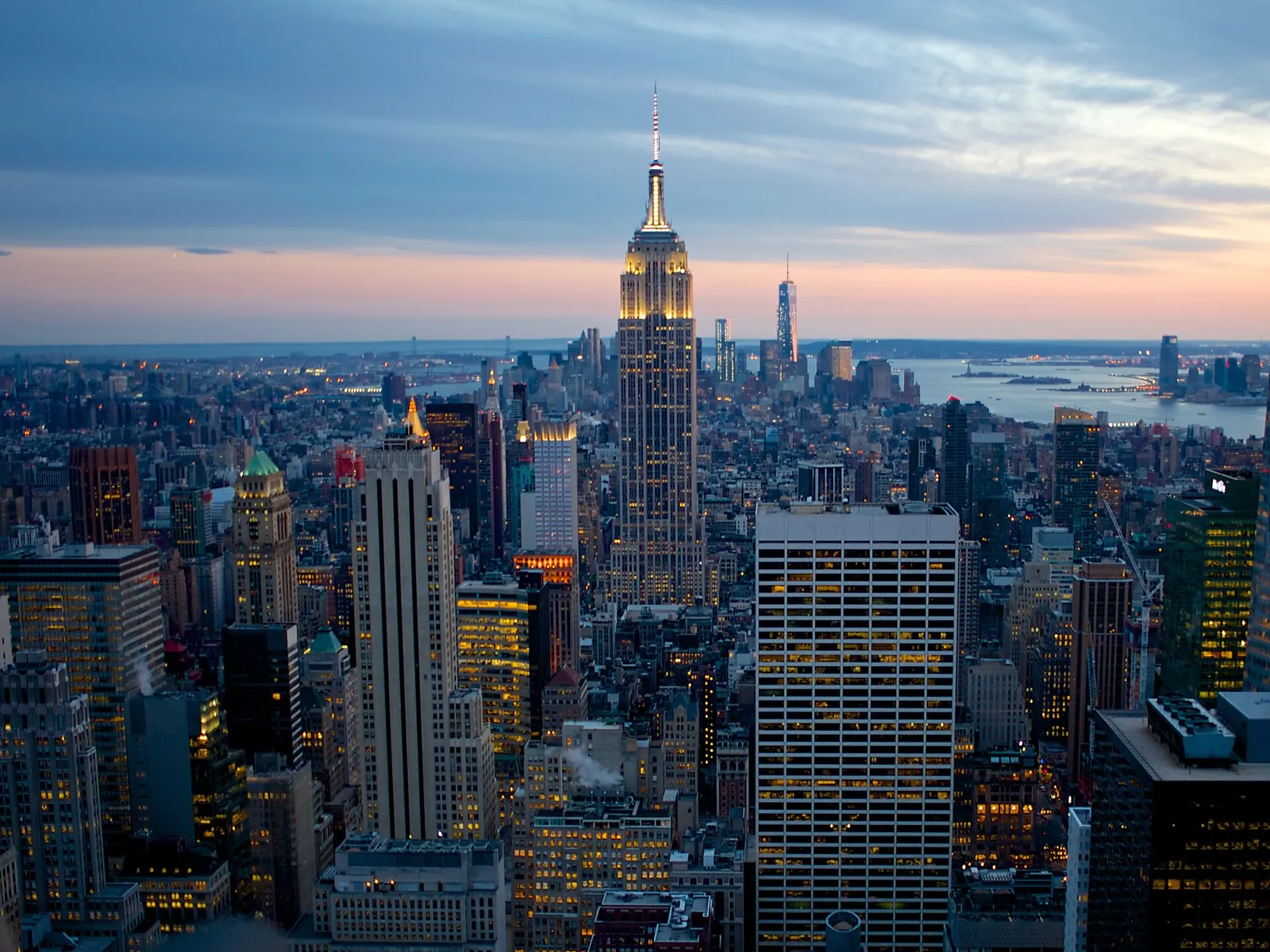 Empire State Building lit up at dusk over Midtown