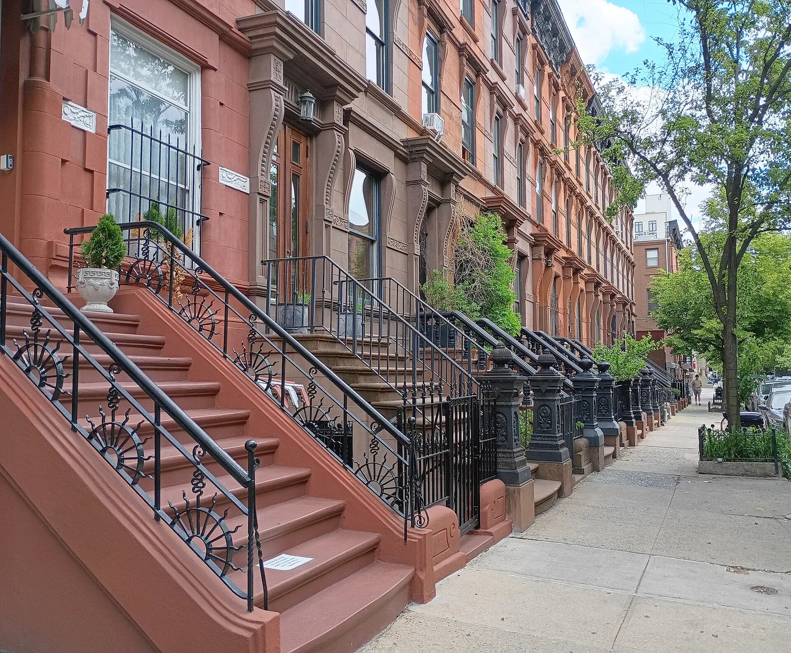 Sunny row of classic brownstones in Harlem