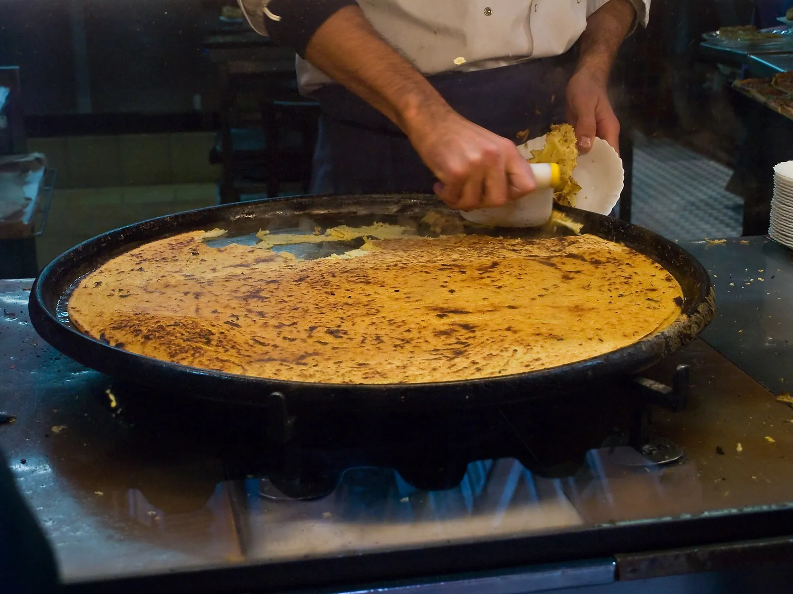 Golden socca crêpe fresh from the pan