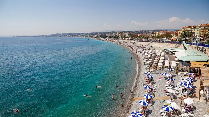 Turquoise Baie des Anges curving along Nice's pebble beach