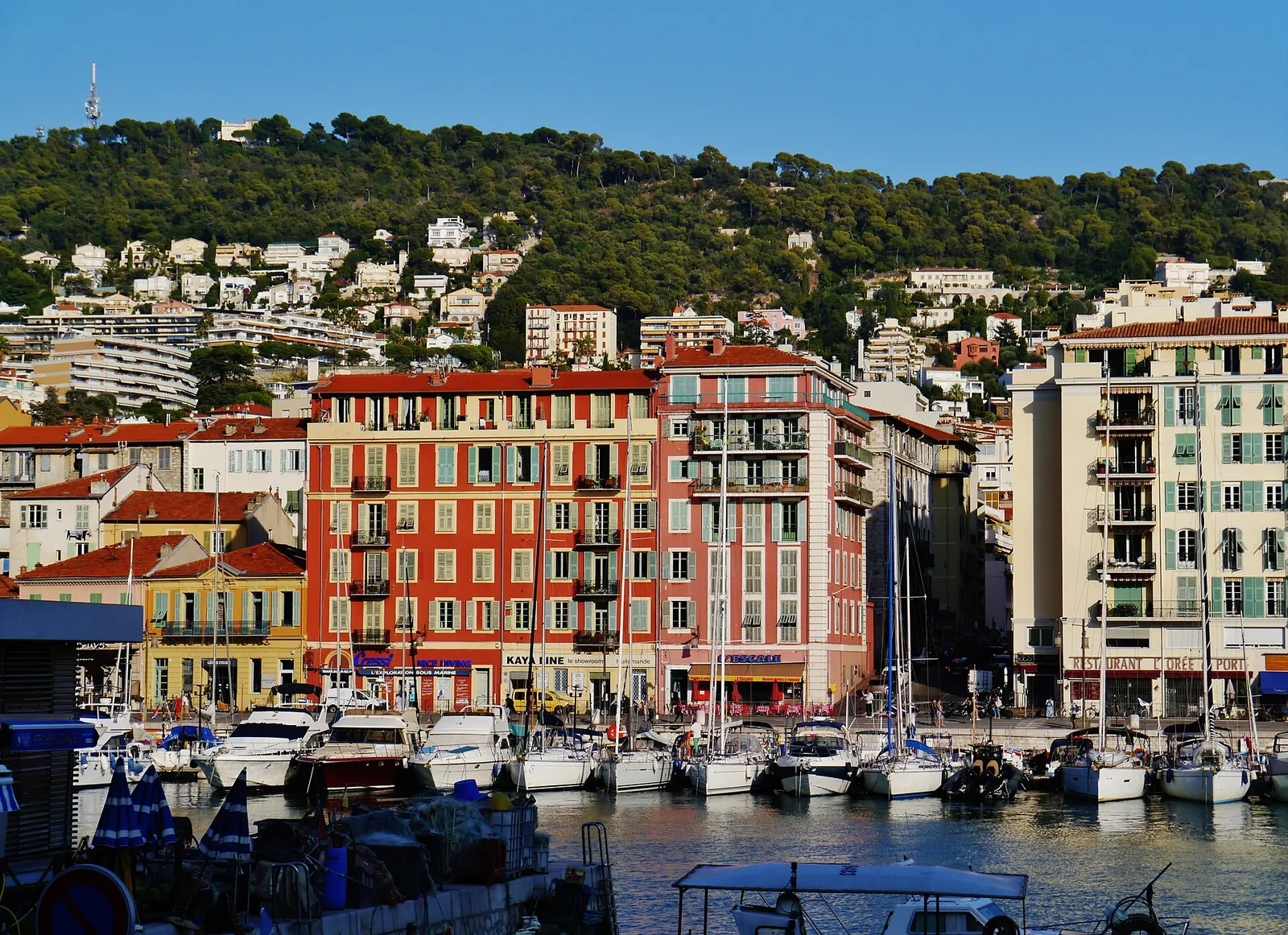 Colourful facades above the boats of Port Lympia
