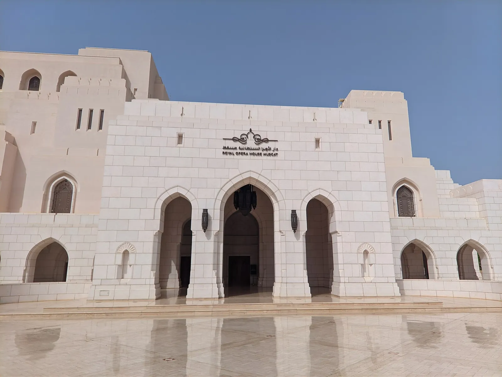 The elegant white facade of the Royal Opera House Muscat