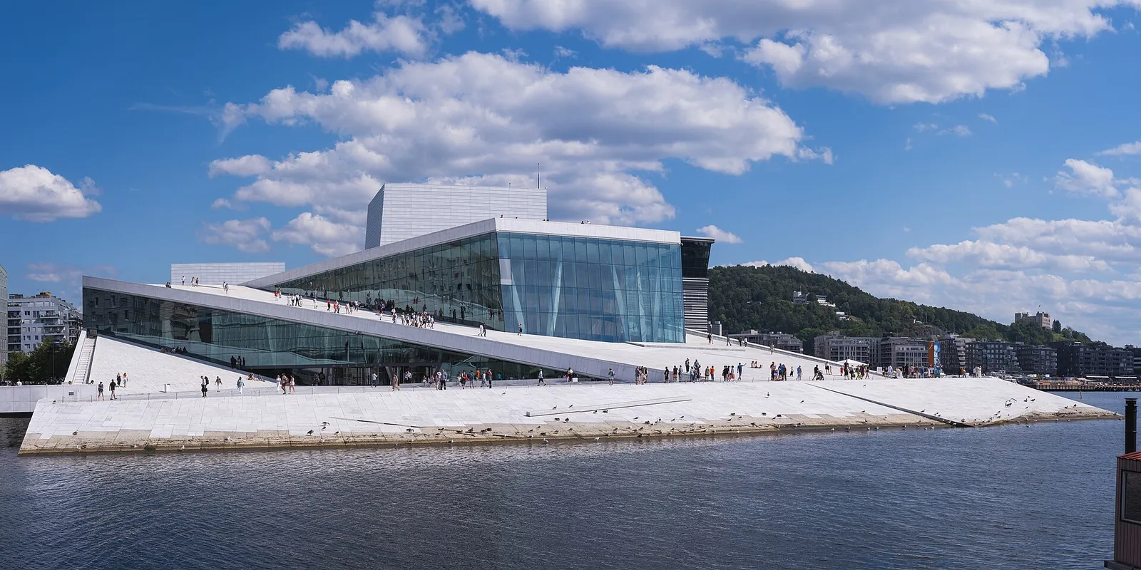 The white marble roof of Oslo Opera House rising from the fjord