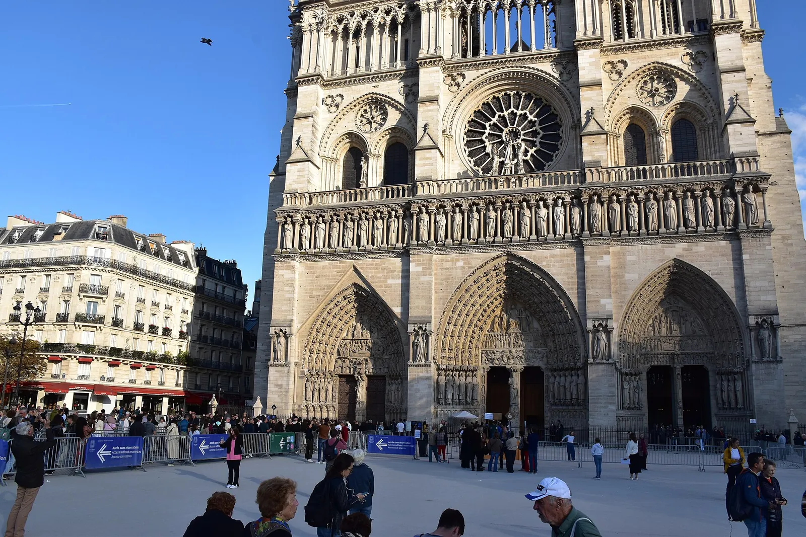 Notre-Dame's restored west front under a blue sky