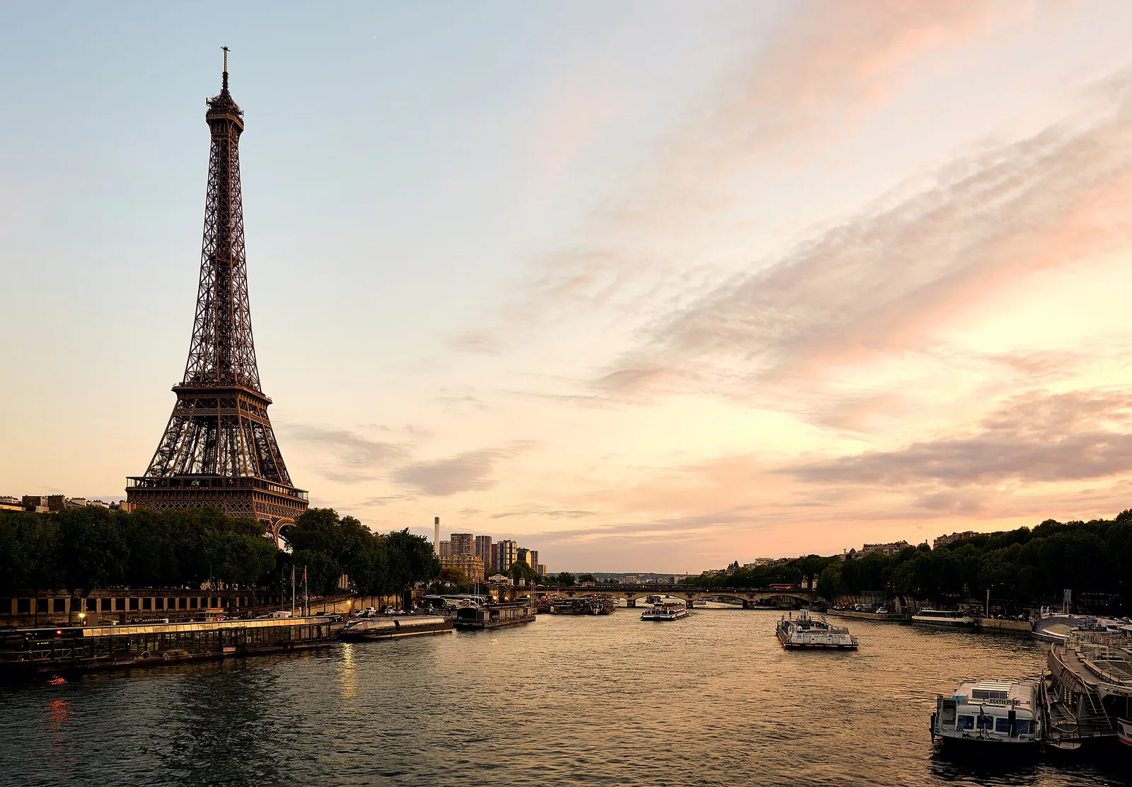 Eiffel Tower above the Seine at a pink sunset