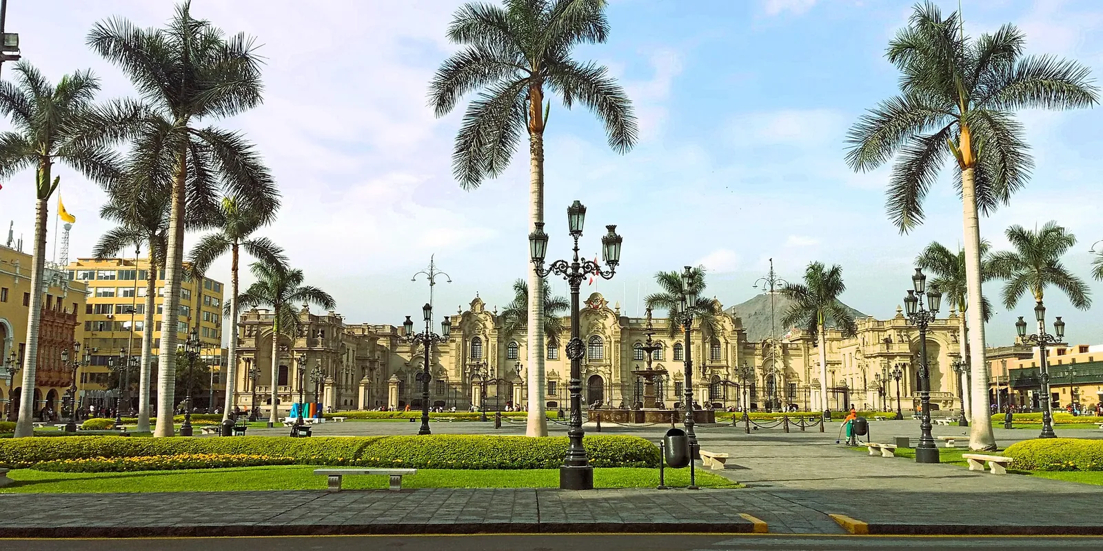 Palm trees and yellow facades on Lima's Plaza Mayor