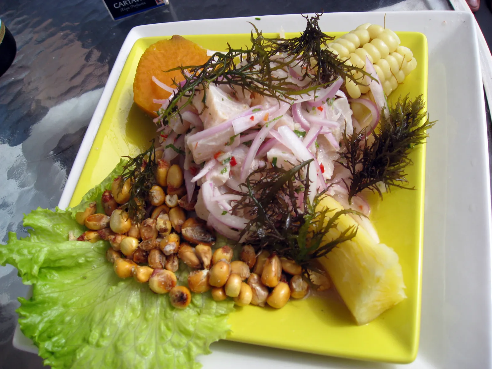 A plate of Peruvian fish ceviche with corn and sweet potato