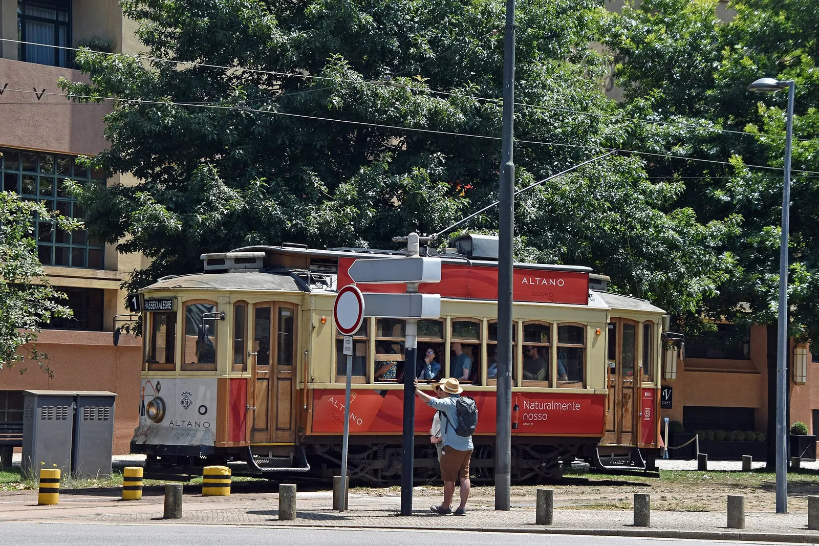 A historic red tram rolling through Porto