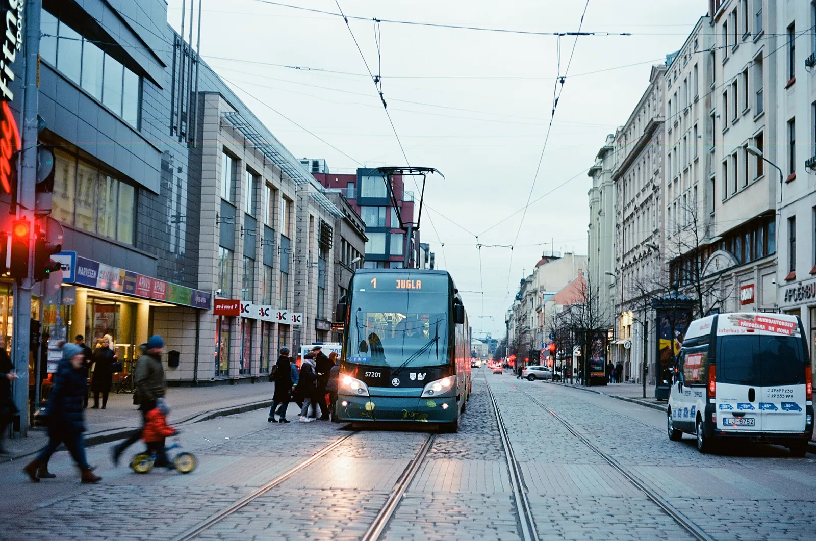 A modern tram on a Riga city street
