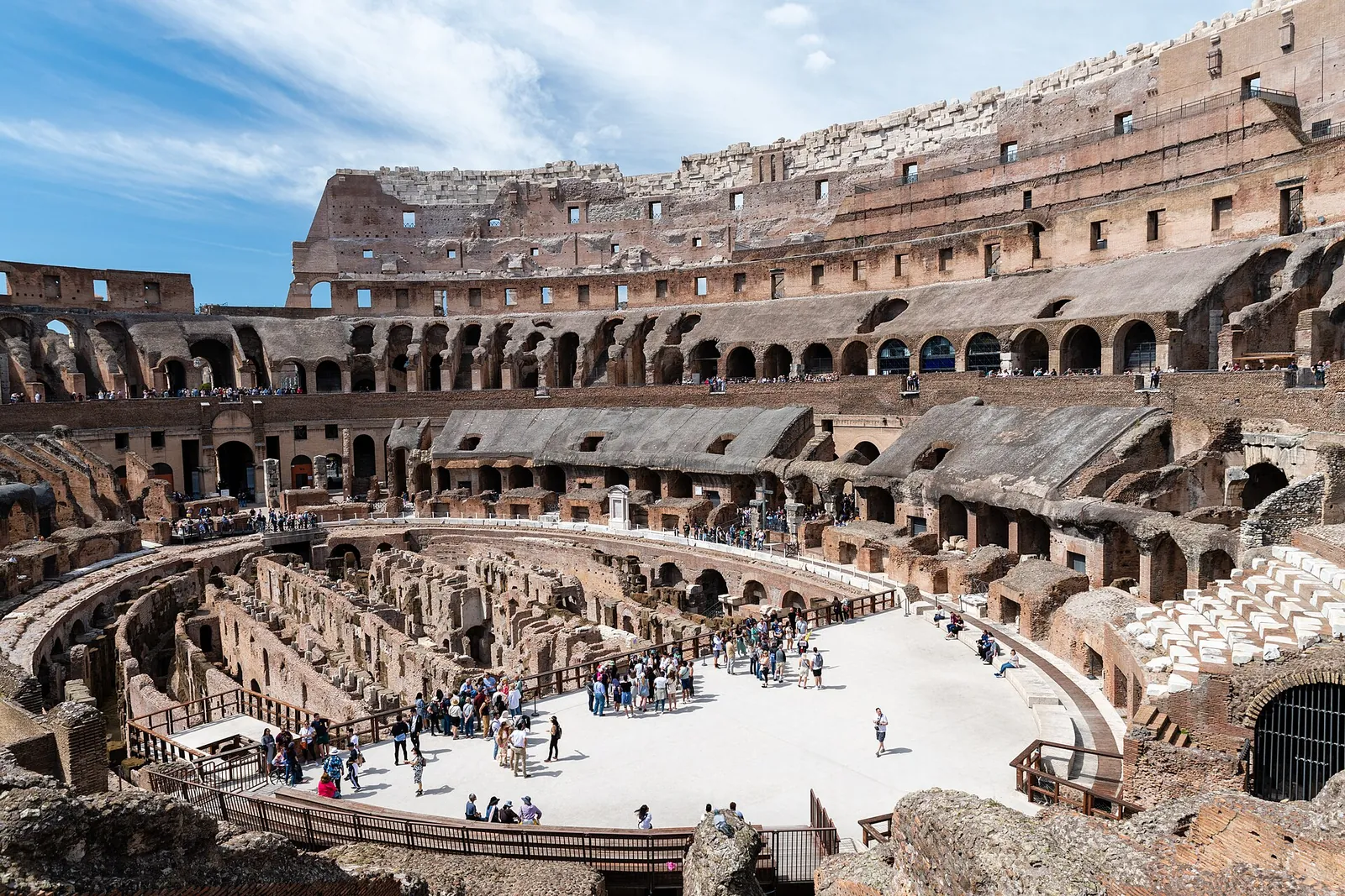 Inside the Colosseum, arches and arena on a sunny day