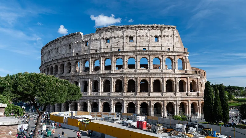 The Colosseum under a bright blue Roman sky