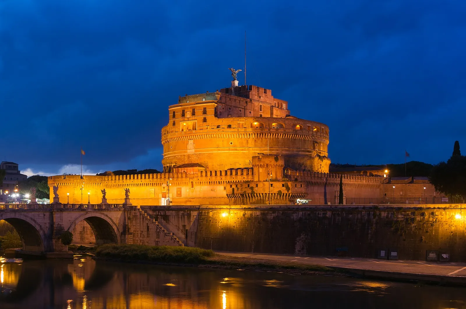 Castel Sant'Angelo glowing over the Tiber at dusk