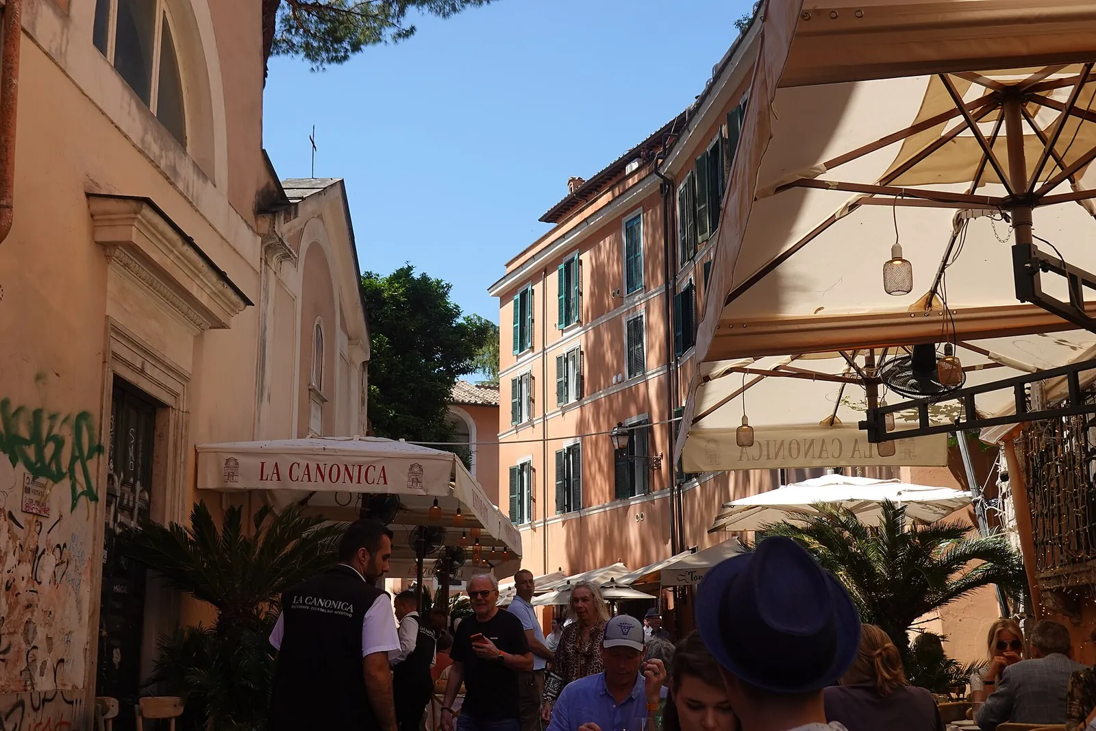 A sunny lane with café umbrellas in Trastevere