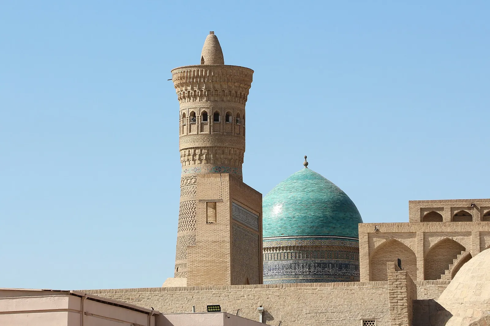 Kalon Minaret and a turquoise dome in Bukhara