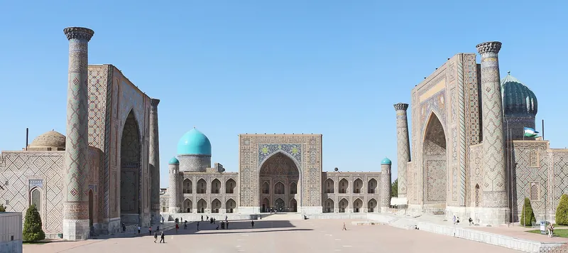 Registan Square's three madrasahs under a clear blue sky