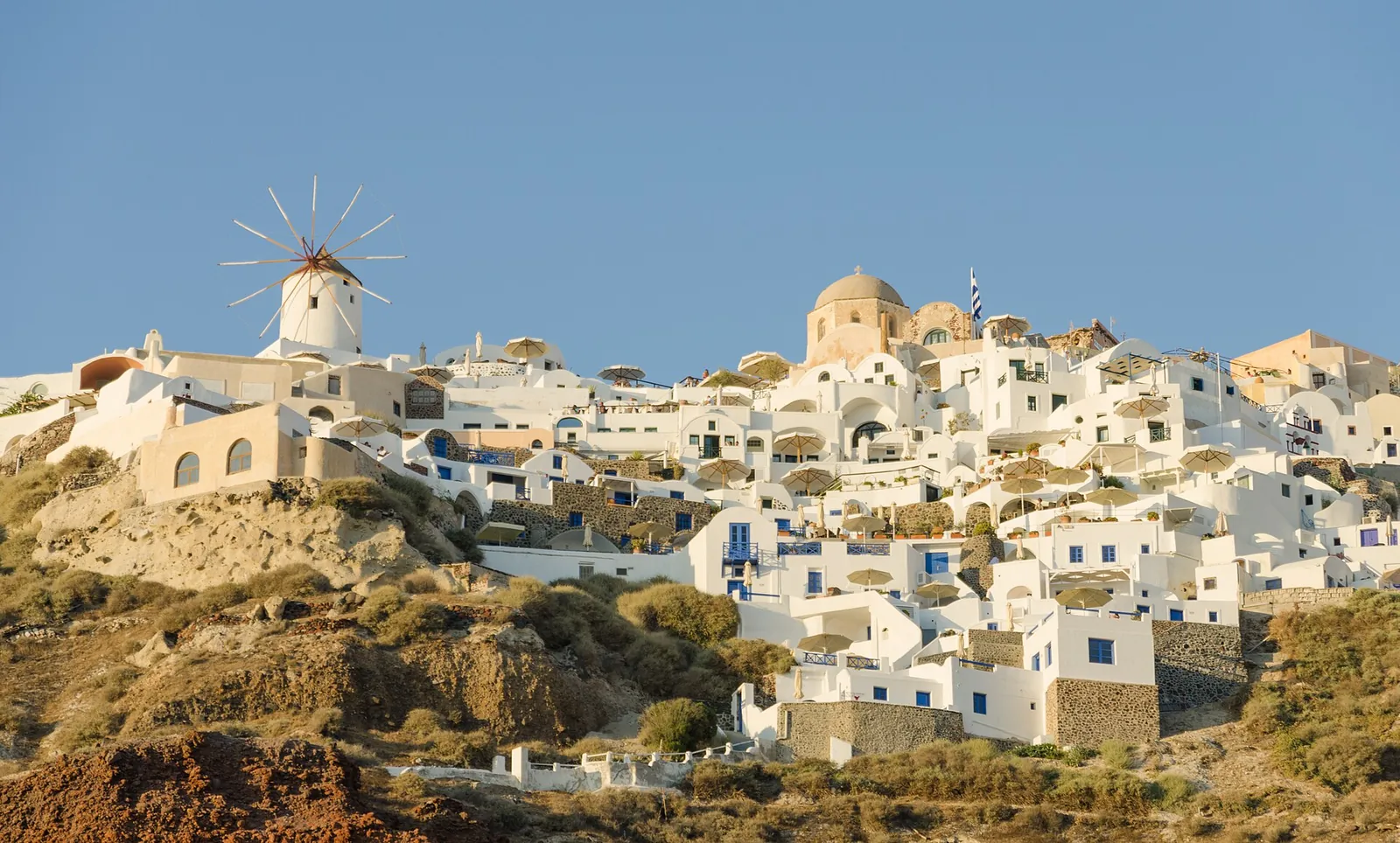 Oia's white houses and windmill on the cliff edge