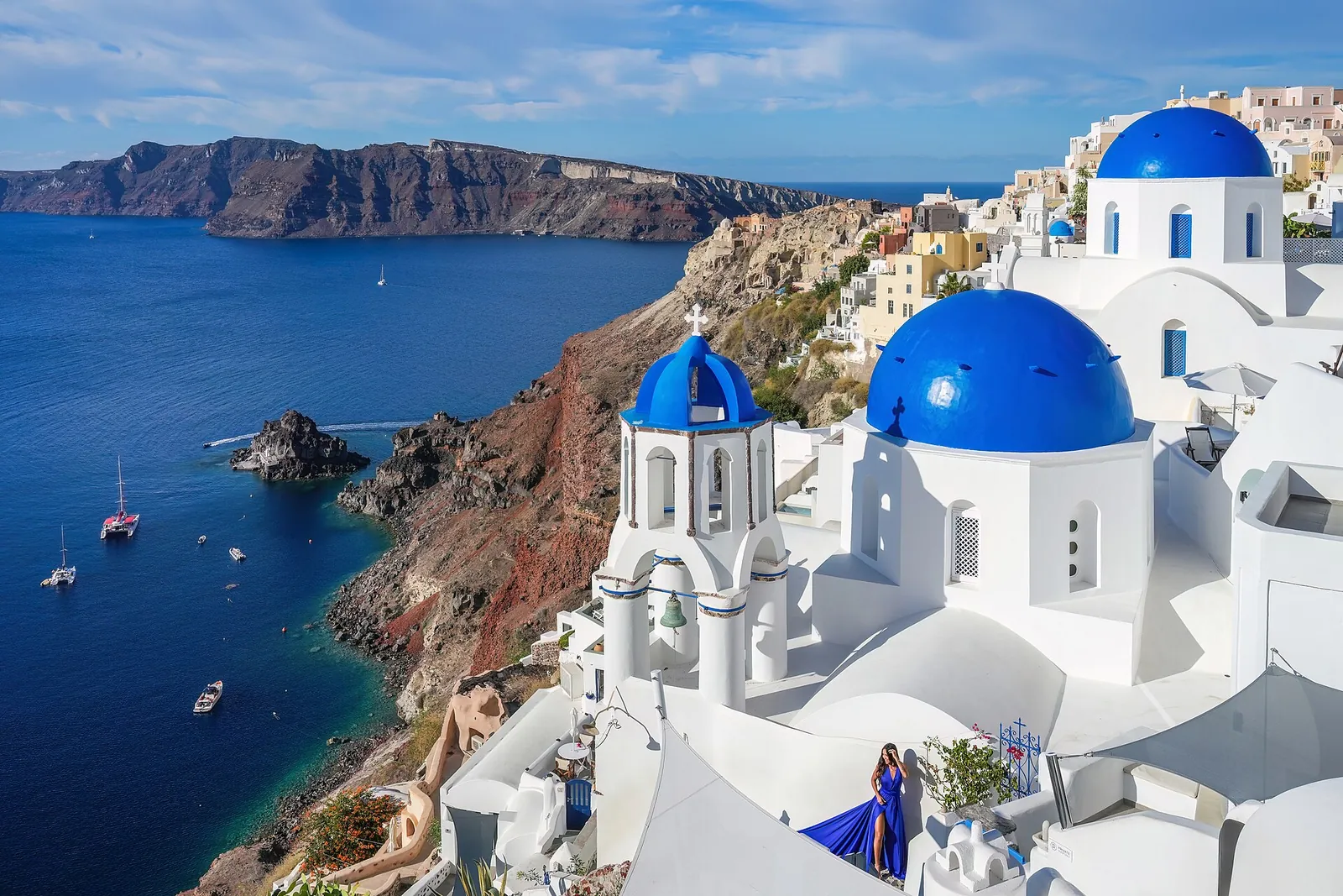 Blue domes of Oia above the shining caldera