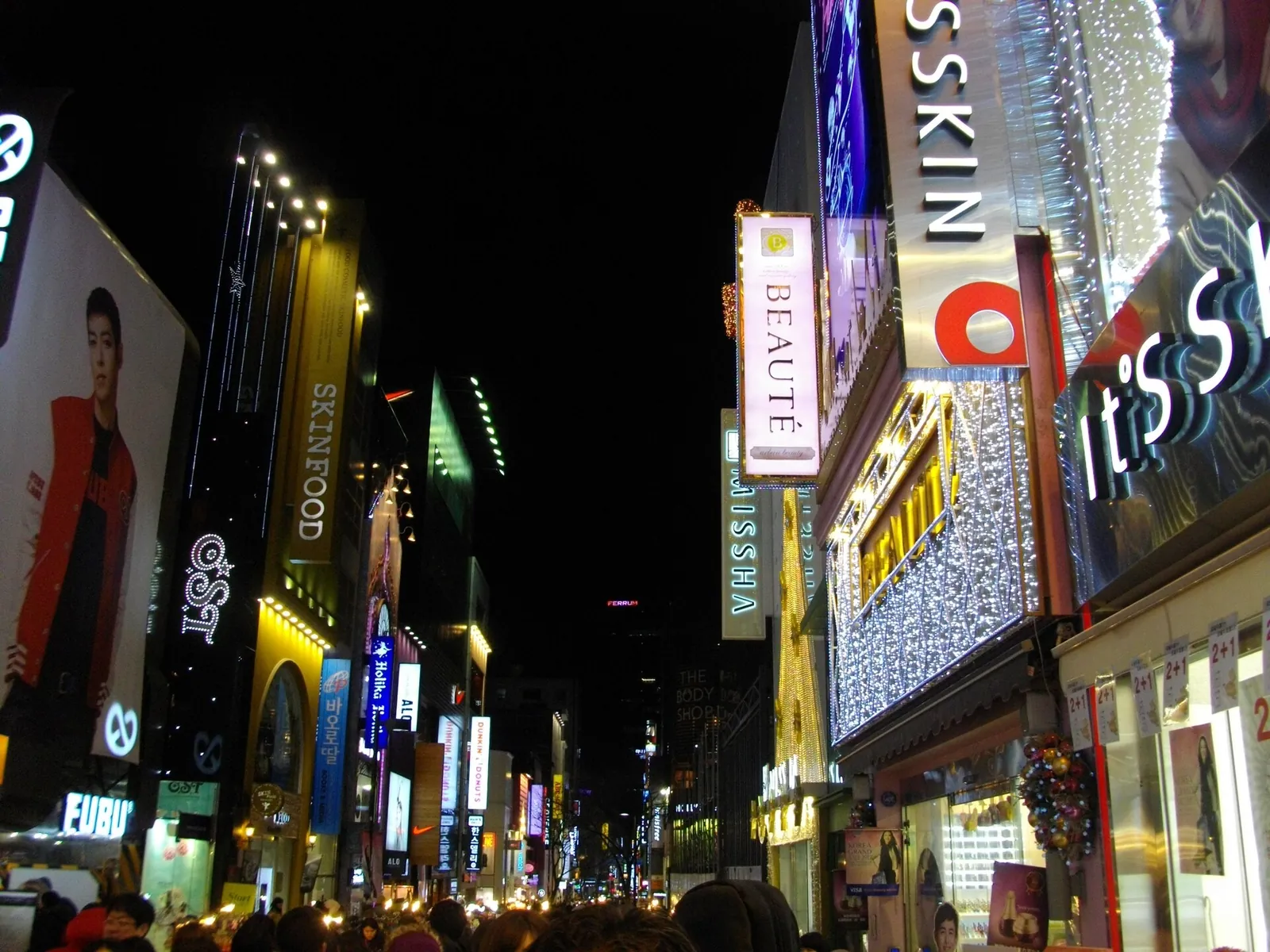 Neon shop signs lighting up Myeongdong at night