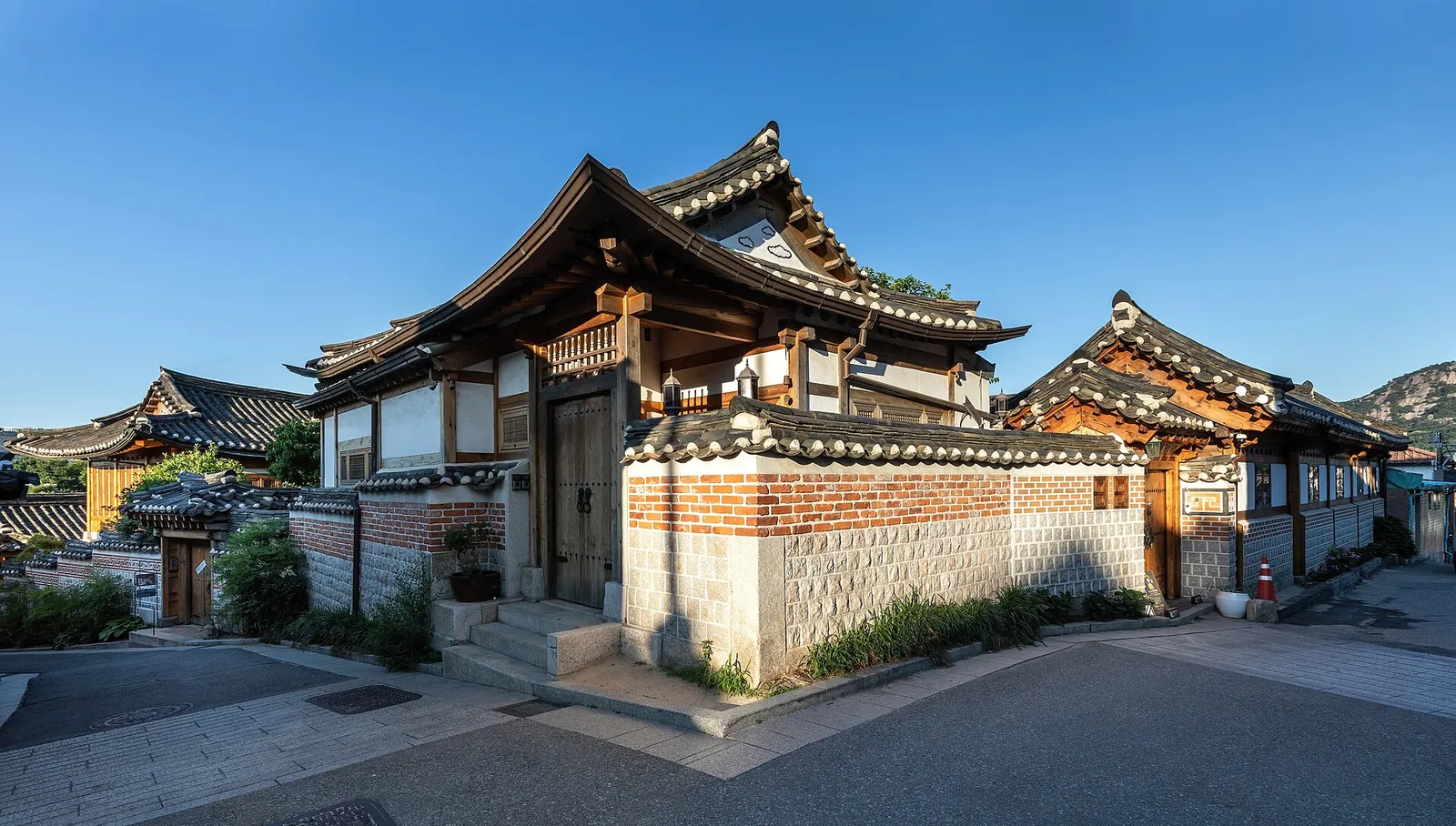 Hanok houses glowing at golden hour in Bukchon