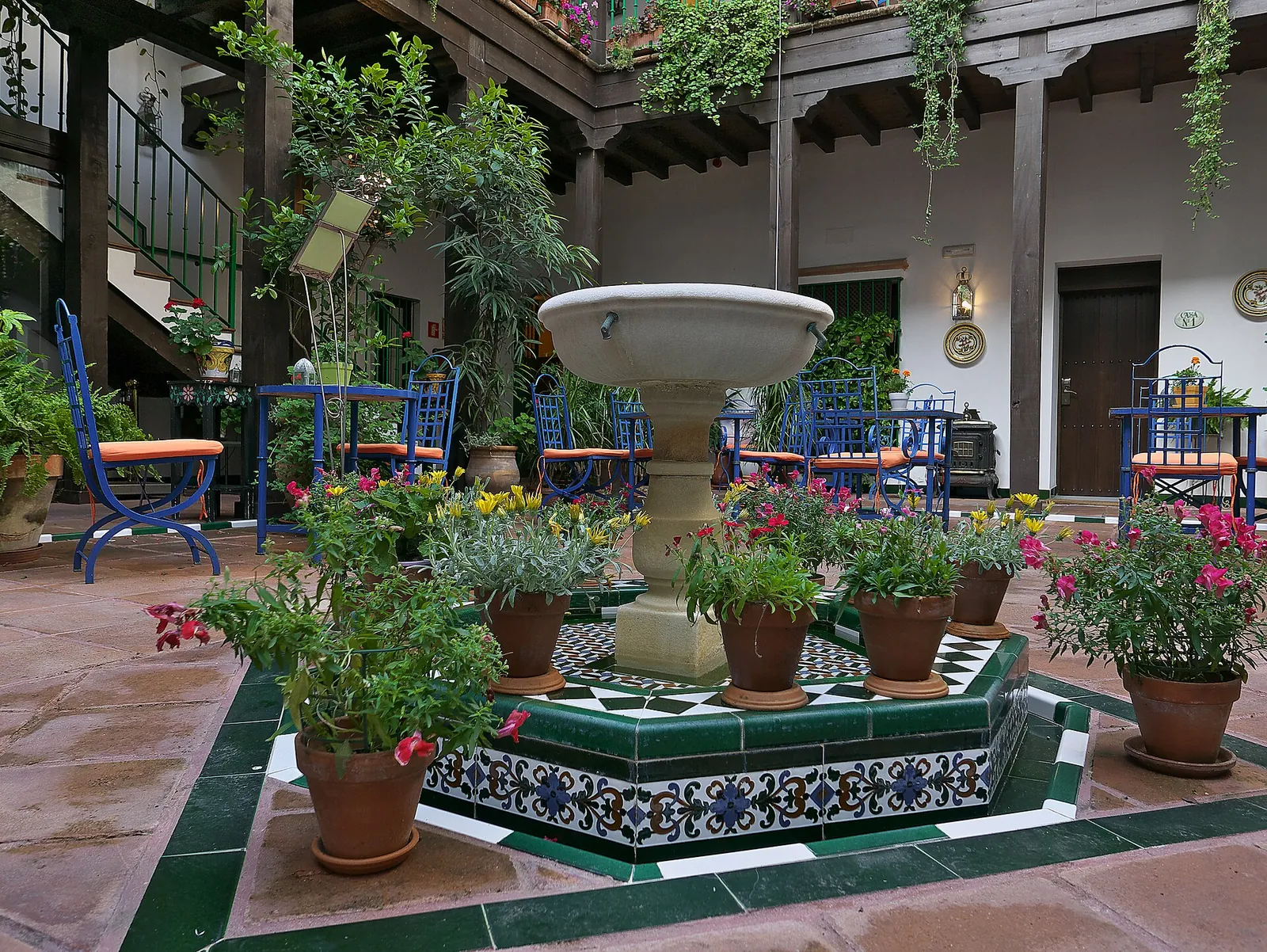 Flower-filled tiled patio in Barrio de Santa Cruz